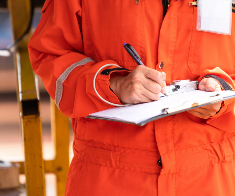 Writing note on paper - Audit and inspection in oil field operation.